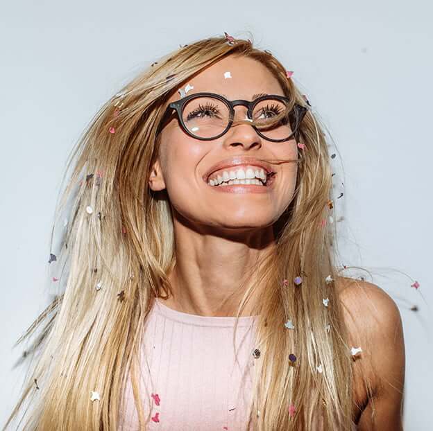 woman smiling with confetti falling