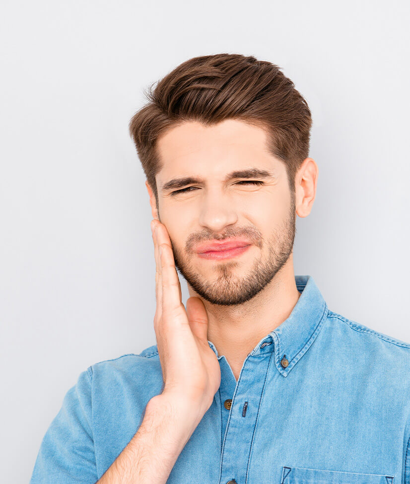 man holding his jaw in pain