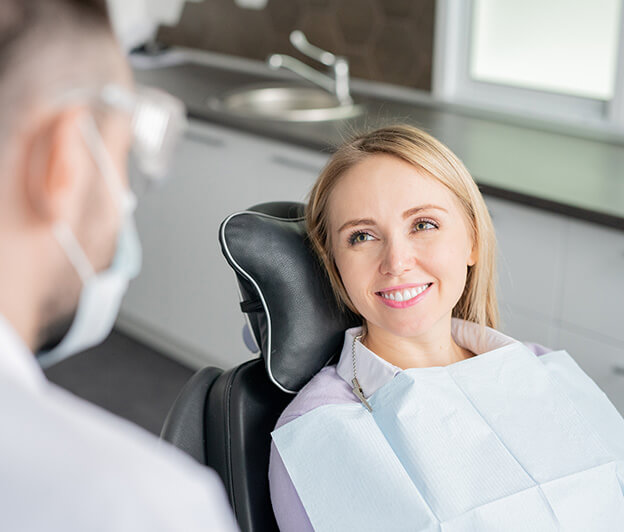 smiling woman sitting in a dental chair