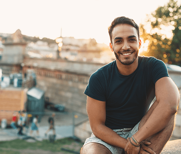 a man sitting outside smiling