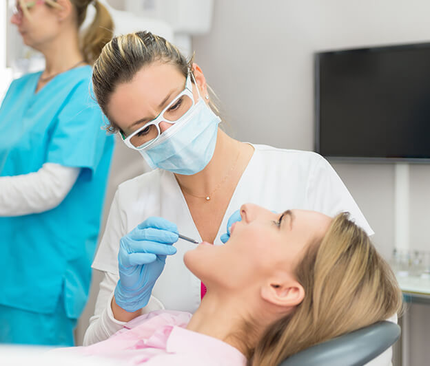 woman having her teeth examined by her dentist