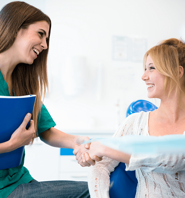 woman shaking hands with dental associate
