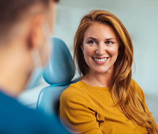 smiling woman sitting in a dental chair